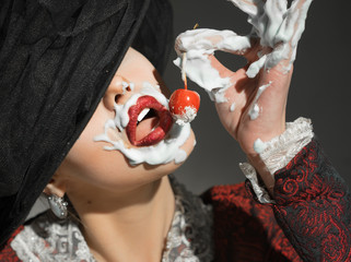 Girl messy eating cake with cherry