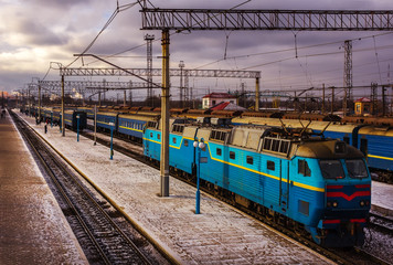 train, near the station platform in stormy weather