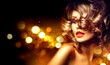 © Subbotina Anna - Beauty woman with beautiful makeup and curly hairstyle over holiday dark background
