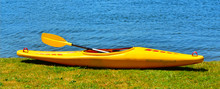 Yellow Kayak On River Bank