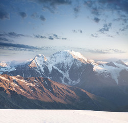 High mountain peak during sunrise. Beautiful natural landscape in the summer time..