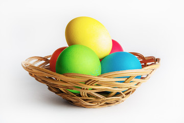 Colorful easter eggs in a wicker basket.