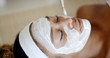 © Dash - Cosmetician applying facial mask to the face of young woman in spa salon