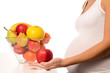 Close-up pregnant woman and fresh fruits