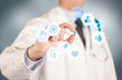 © ra2 studio - A doctor in white holding a pill