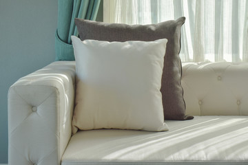 Wall Mural - Black and white pillow on beige sofa with natural light in the living room