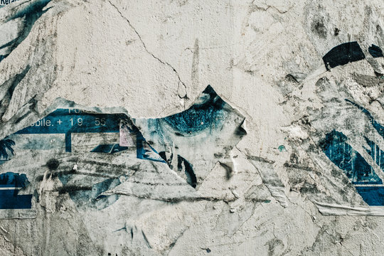 Concrete wall with scraps of paper