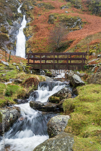 Naklejka na szybę Rhaeadr Bach Falls are in the Snowdonia National park, North Wales after a heavy rainfall. The bridge is part of the North Wales Path, a popular long distance path with walkers. 