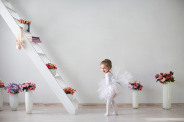 Full length portrait of a little pretty ballerina.