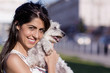 © boryanam - beautiful smiling young woman hugging her small white poodle dog outdoor