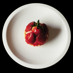 Fresh strawberry cake on the white plate