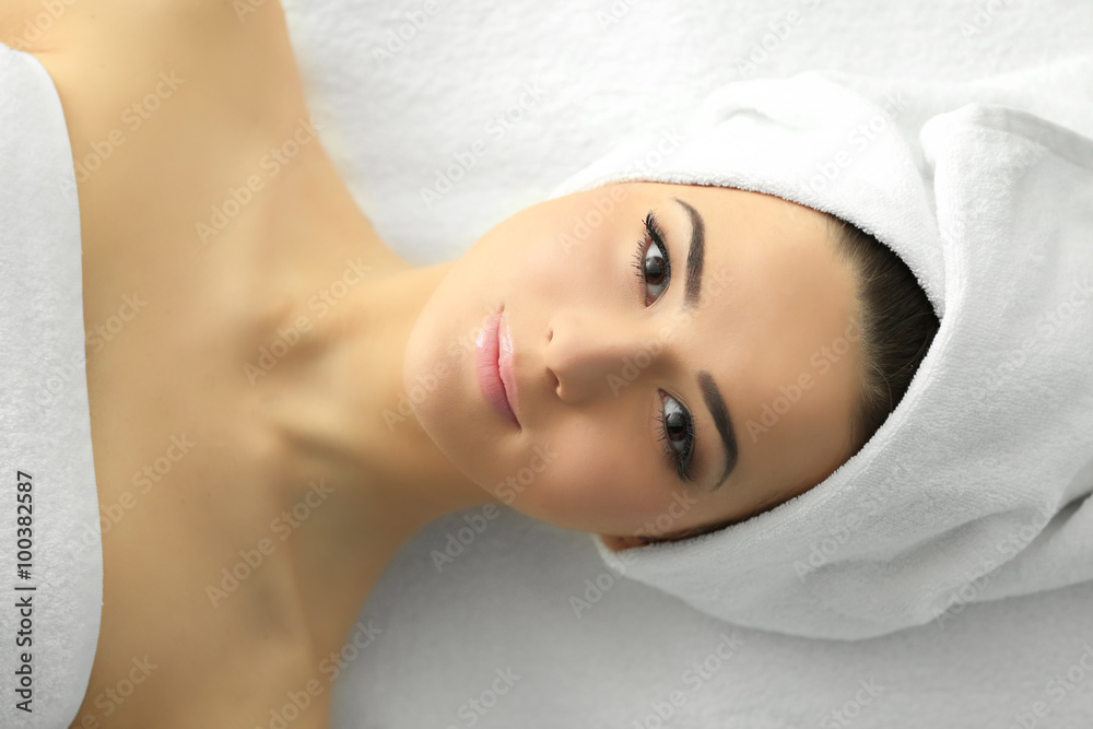 Spa concept. Face massage. Young woman getting spa treatment, close up