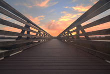 Wooden Boardwalk At Sunset At Bolsa Chica Wetlands Preserve In Huntington Beach, California, United States