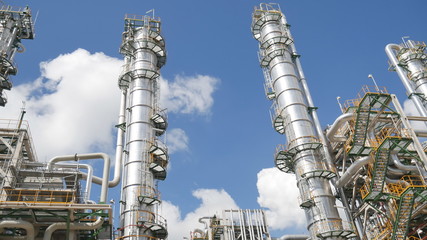 Wall Mural - Refinery tower and steel pipe line in process area of Industrial refinery plant with blue sky 