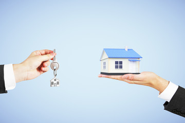 Poster - Real estate concept with man hand with key and house in another