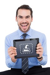 Sticker - Composite image of happy businessman showing his tablet pc 