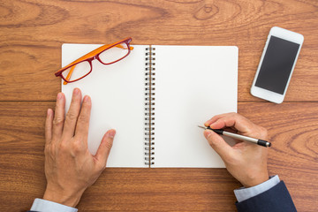 Businessman hand writing on notebook