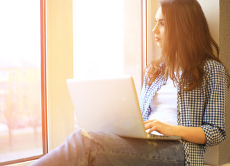 Girl working on computer in light room