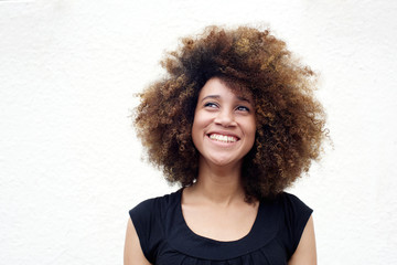 Young african woman smiling and looking up