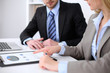 © rogerphoto - Two successful business partners working at meeting in office