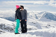 © guruXOX - Couple kissing in the snow / Young couple in love kissing on top of a mountain. Les 2 Alpes, French Alps