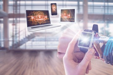 Poster - Composite image of hand using smart watch