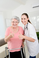 young doctor checking rehab medical progress to an elderly woman at home