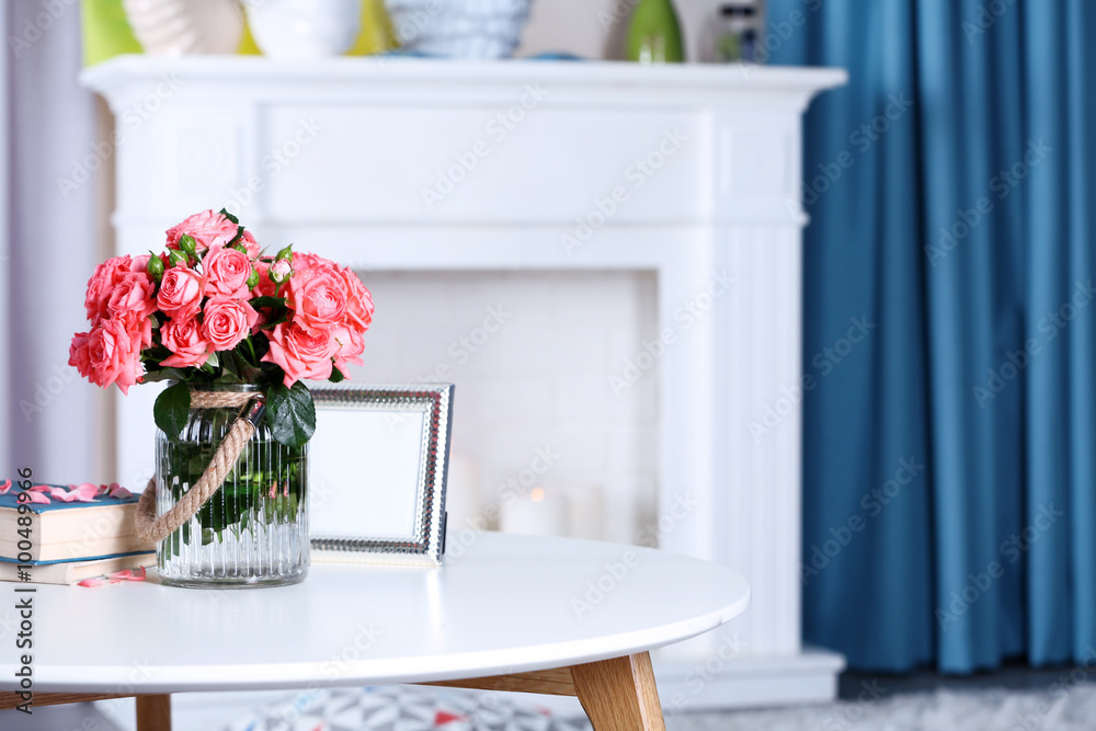 Beautiful rose in vase on table in room