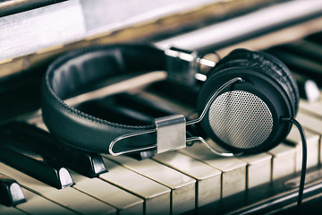 Wall Mural - Headphones on piano keyboard, close up