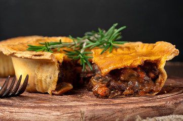 Piece of Australian meat pie with rosemary