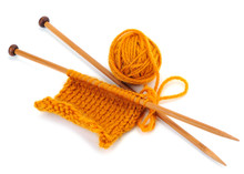 Yellow Yarn Of Knitting With Needles And Ball