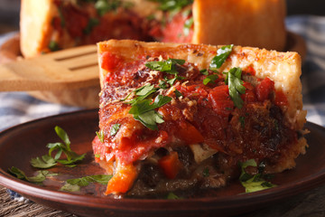 Slice of Chicago deep dish pizza on a plate macro. Horizontal
