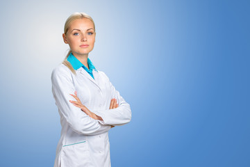 Beautiful smiling doctor woman in medical gown