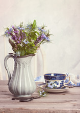 Flowers In Antique Jug With Teacup