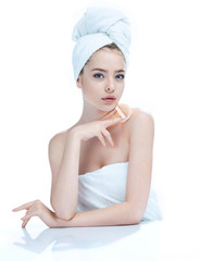 Wall Mural - Pretty young girl enjoy a flawless skin, skin care concept / photo composition of blonde girl in towel - isolated on white background