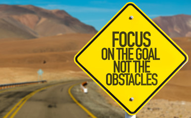 focus on the goal not the obstacles sign on desert road