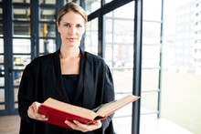 Female Lawyer Reading A Book Attentively