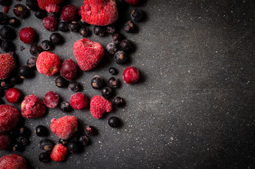 Wall Mural - Frozen berries on dark background