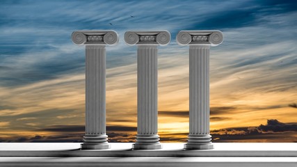 Three ancient pillars with sunset sky background.