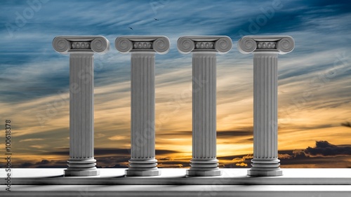 Fotografía Four ancient pillars with sunset sky background.