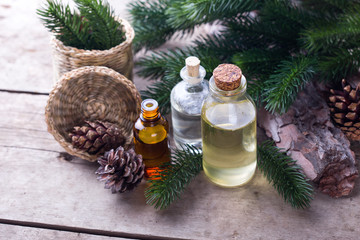 Wall Mural - Bottles with fir tree essential aroma oil  on  aged wooden backg