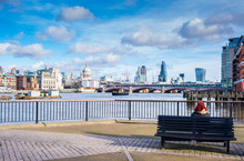 Tourist Sitting Down On Bench Admiring Iconic London View