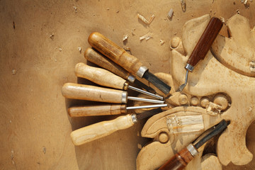 Wall Mural - carving tool closeup on wooden background