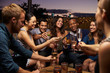 © Monkey Business - Group Of Friends Enjoying Night Out At Rooftop Bar
