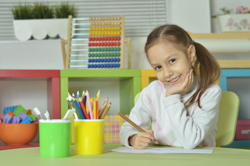Wall Mural - little girl drawing at home