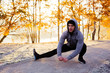 © baranq - Athletic runner stretching his legs after running workout