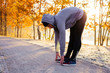 © baranq - Young runner stretching before winter run