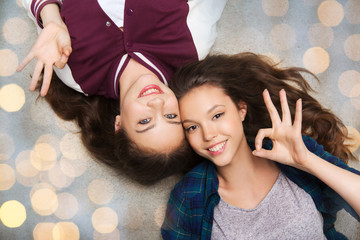 Poster - happy smiling pretty teenage girls lying on floor