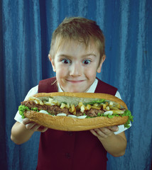 Boy eating big sandwiches