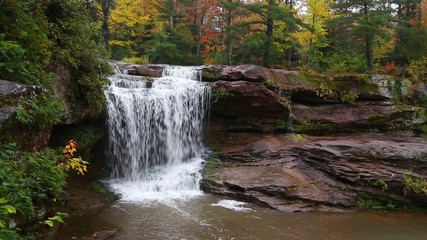 Wall Mural - Whitewater tumbles over O Kun De Kun Falls, a beautiful remote waterfall in Michigan's western Upper Peninsula, in an autumn landscape.